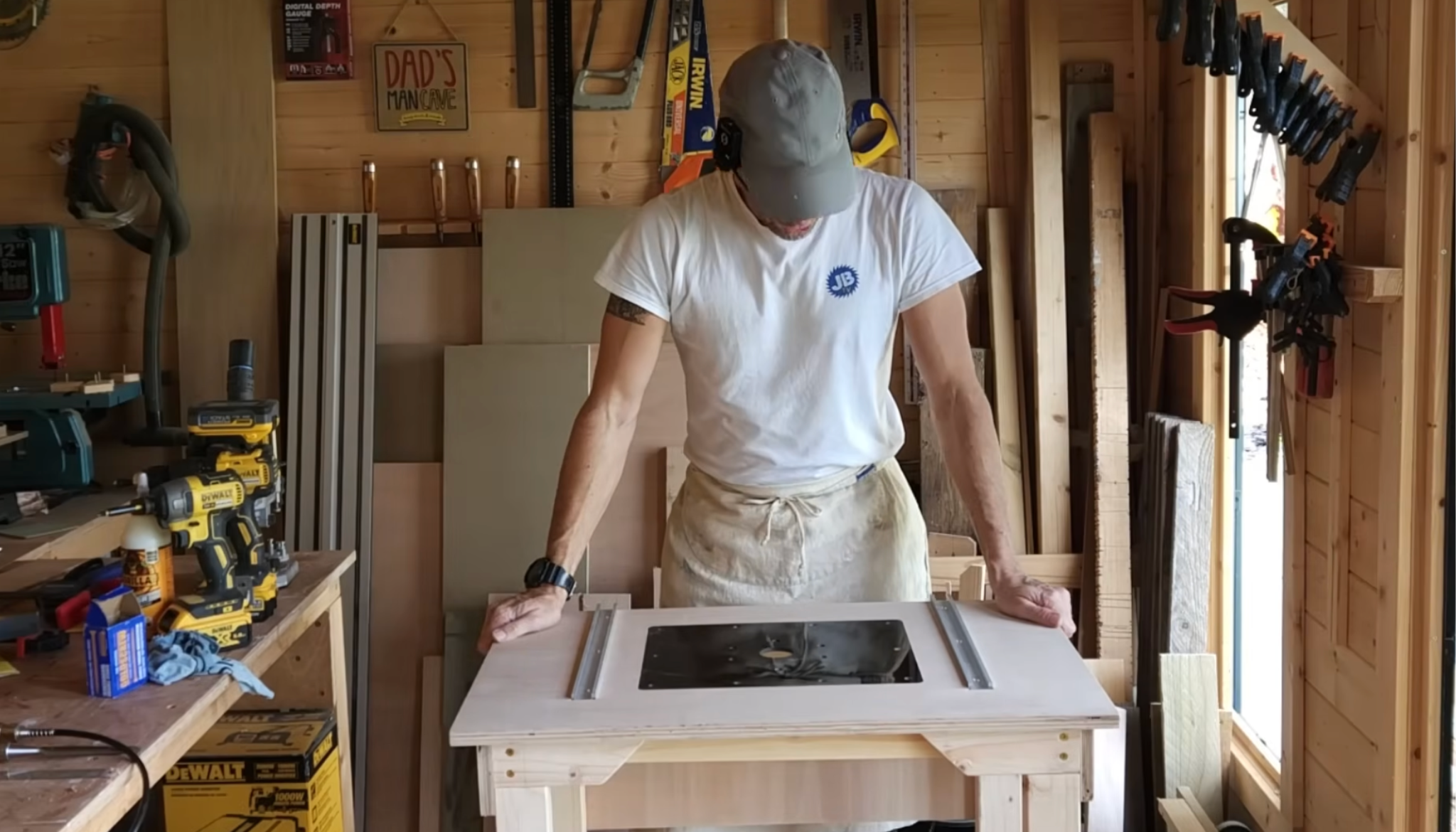 person marking and grooving t-track on router table tabletop for fence and clamps installation