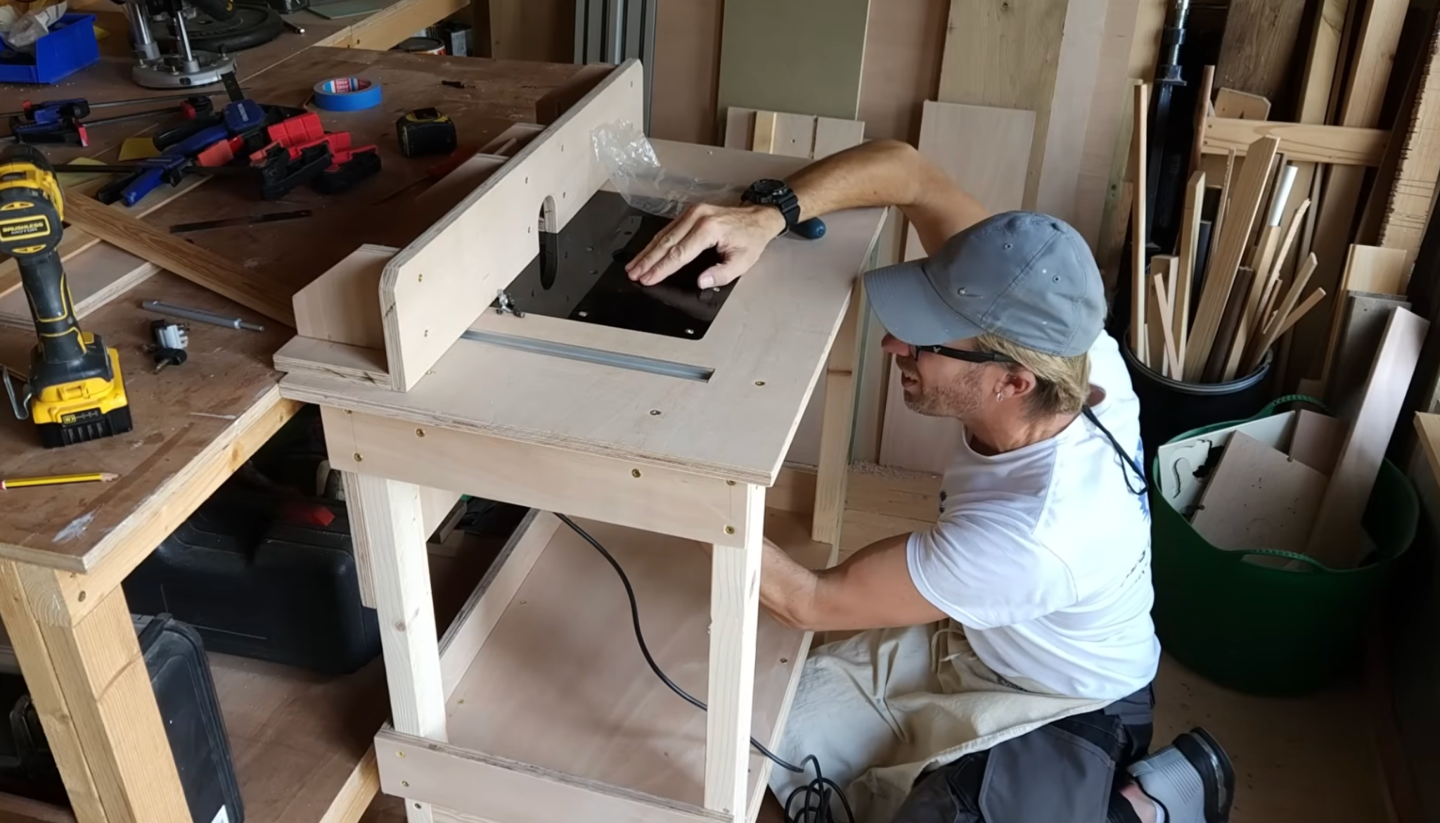 person securing a router into the table plate ensuring proper alignment and stable setup