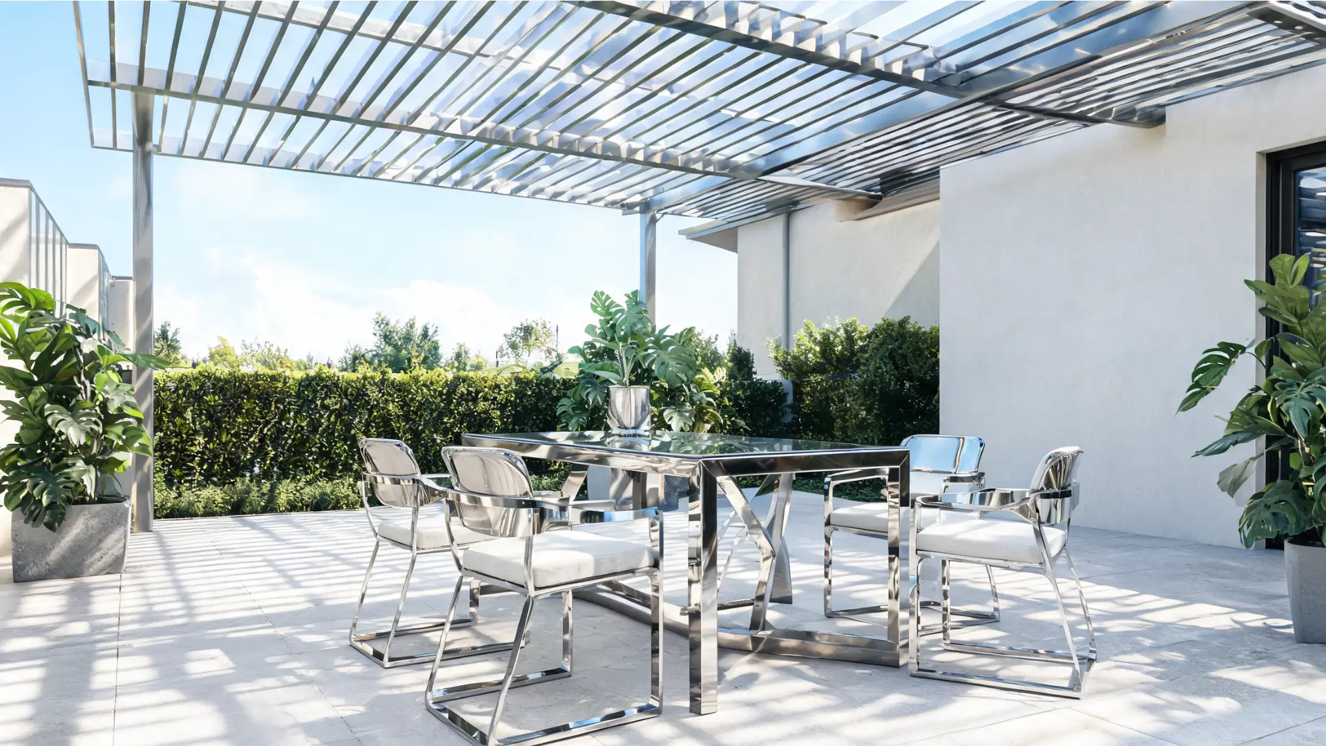 stainless steel outdoor dining table and chairs on a modern covered patio with greenery