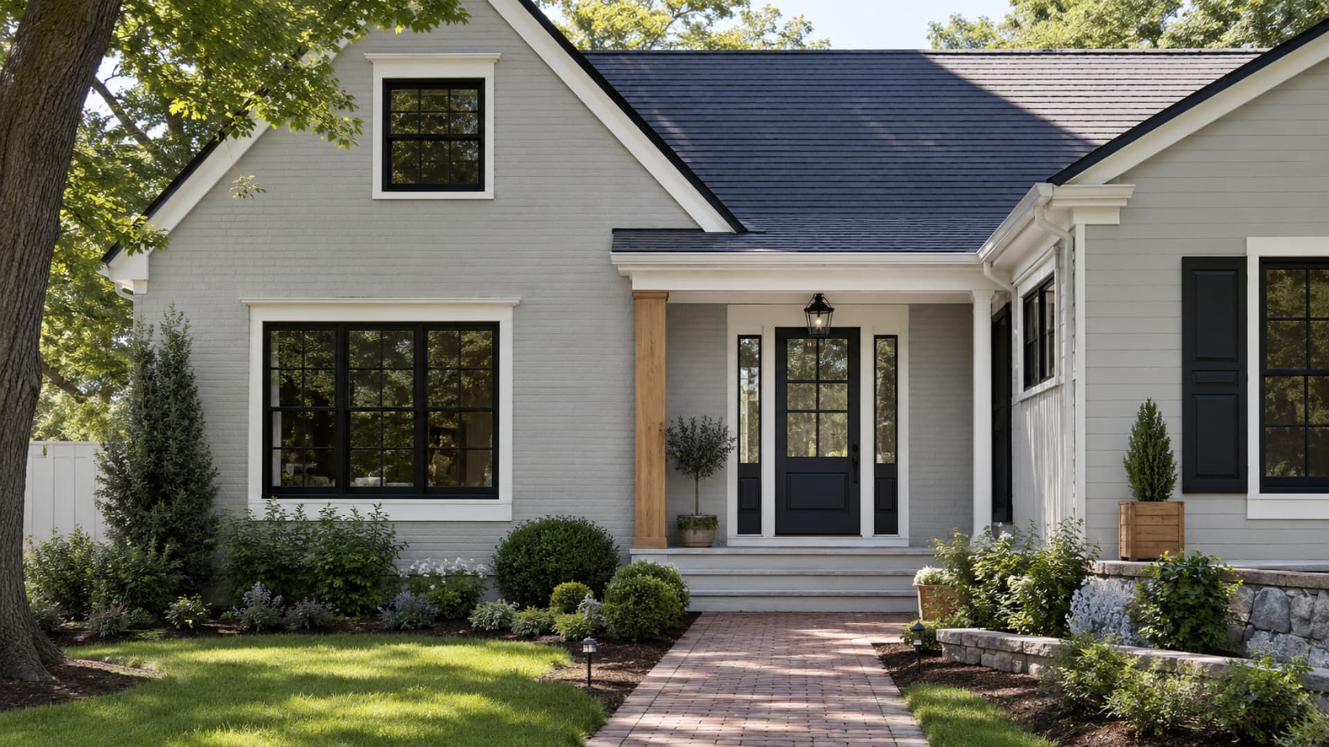 Stonington Gray exterior with white trim, black windows, navy door, warm cedar, and stone accents
