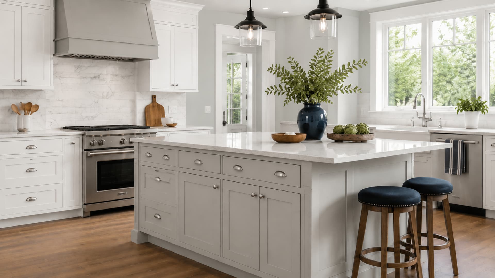 Stonington Gray kitchen walls with soft white cabinets, navy stools, and warm wood flooring