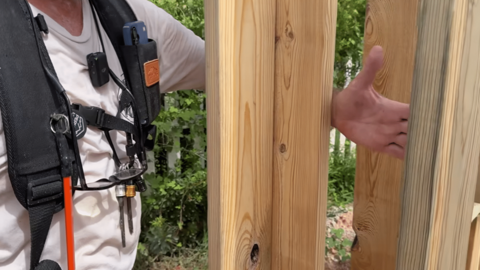 support posts being leveled and secured beneath porch beams during framing work