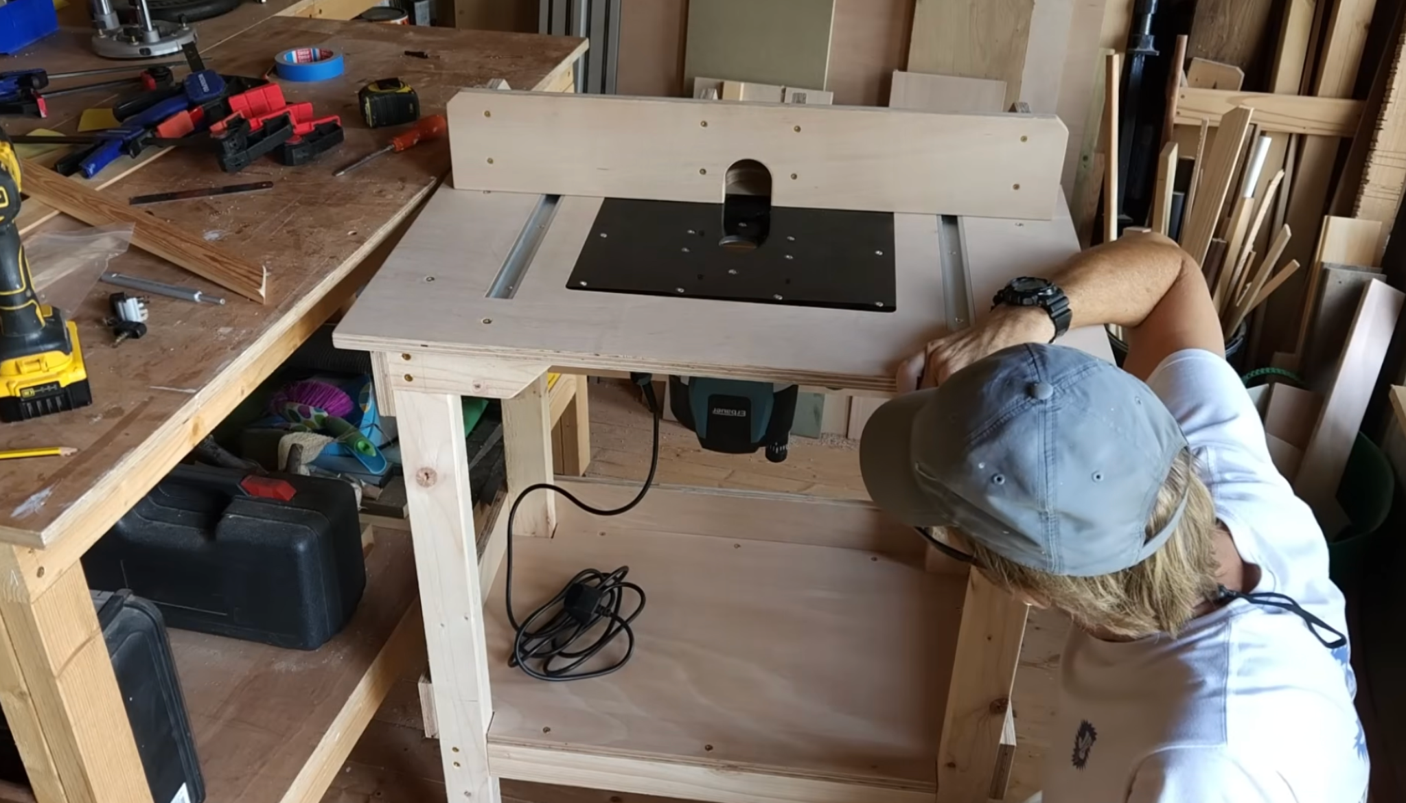 testing the diy router table by powering the router and checking stability and fence movement