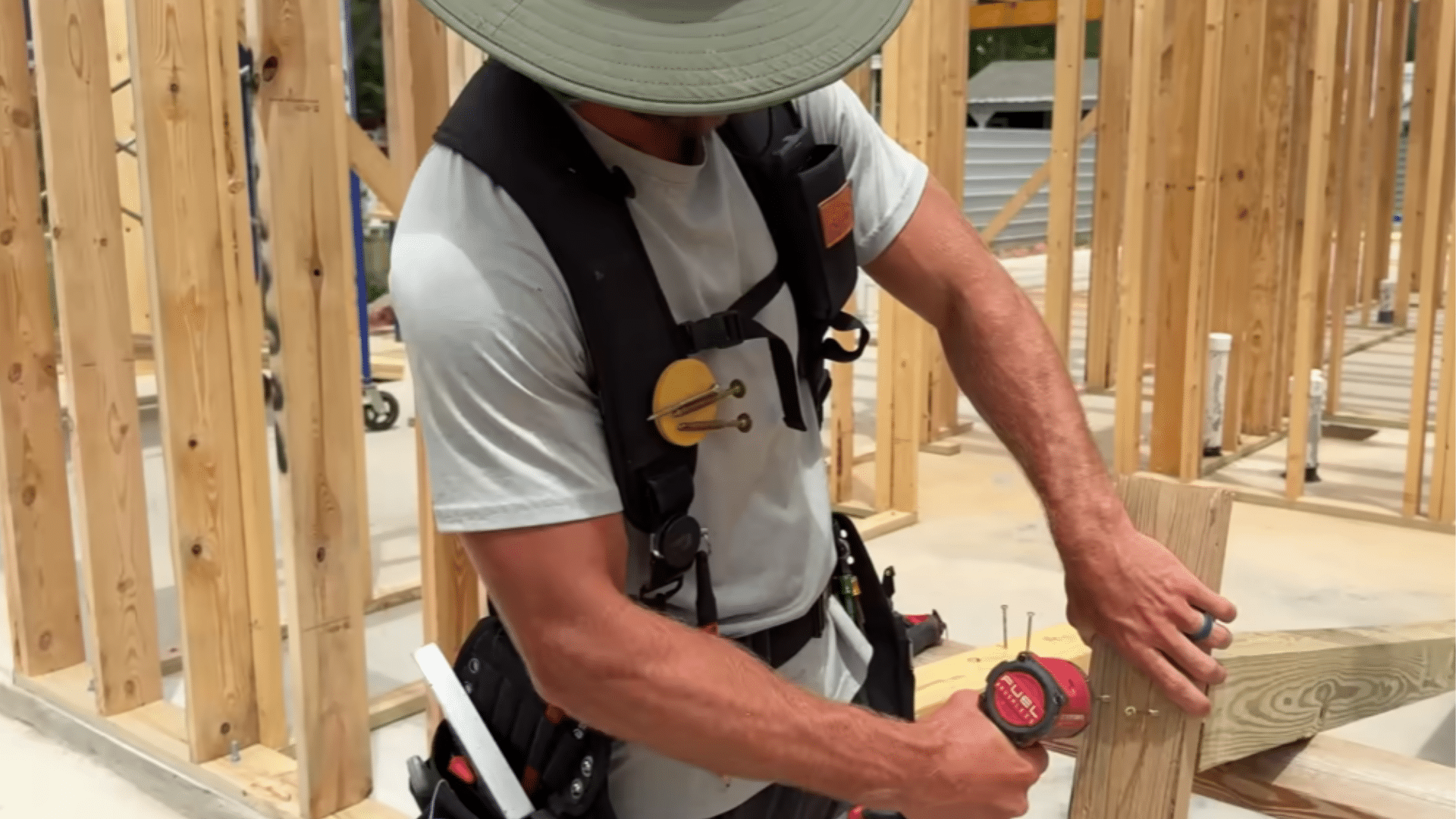 workers lifting and positioning front porch beam onto support posts during construction