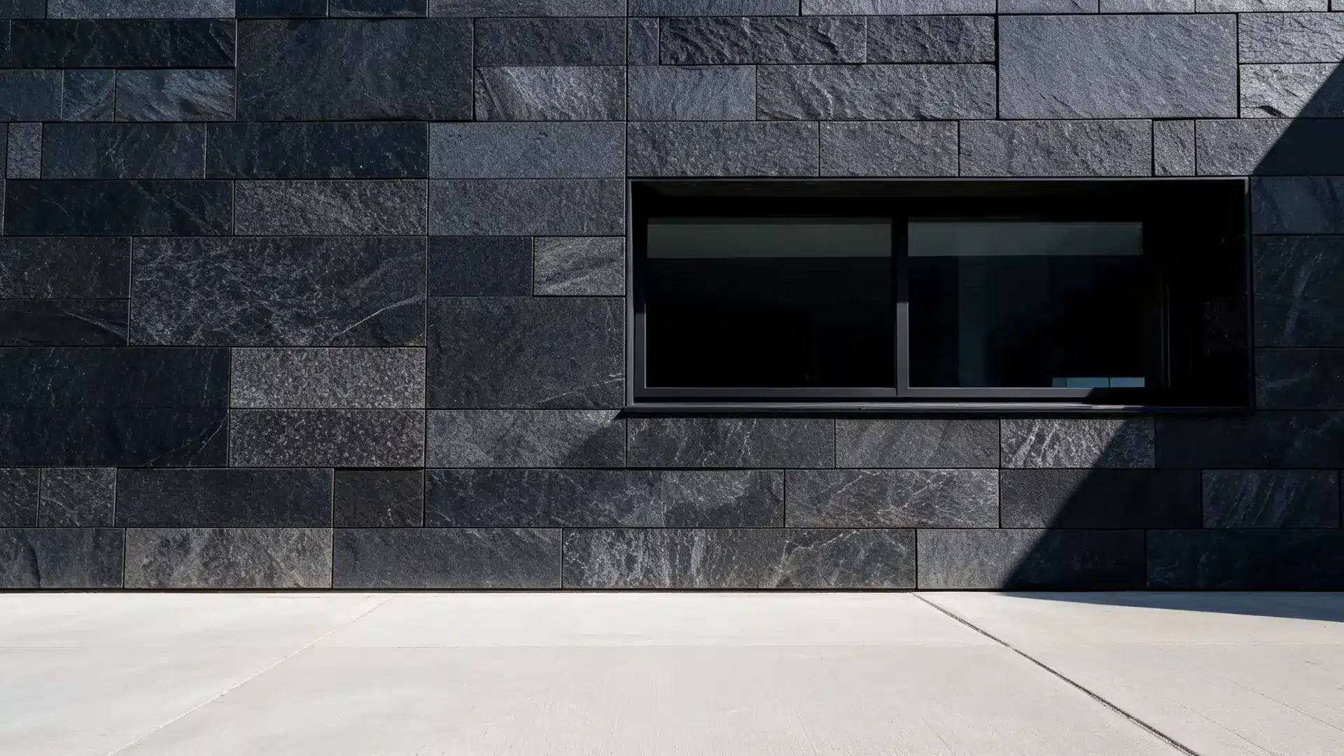 dark basalt stone panels on a minimalist modern exterior