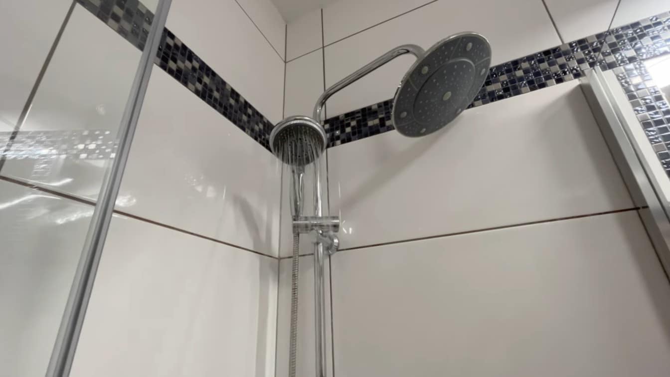 how to clean shower head after soaking with water running from the fixture to rinse loose buildup away