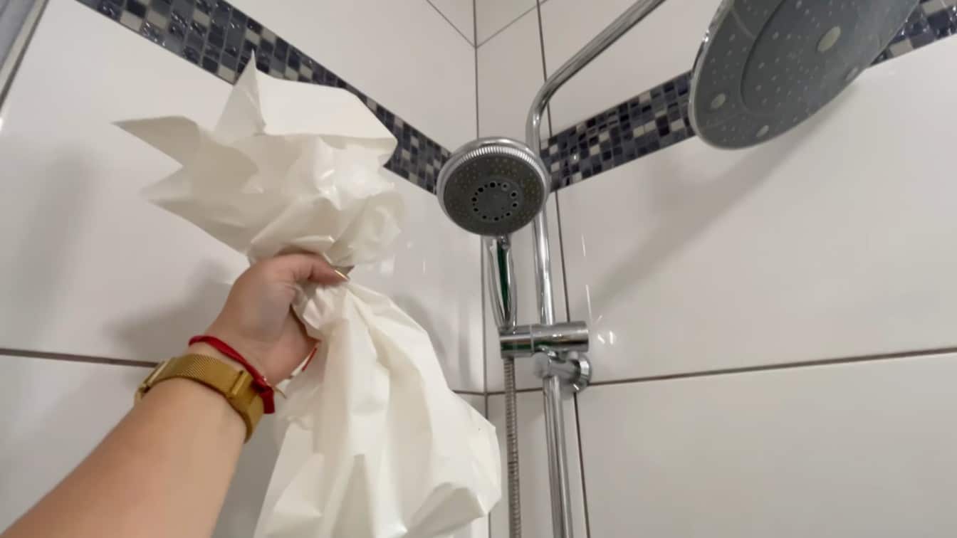 how to clean shower head while taking off the vinegar bag after soaking away hard water buildup at home