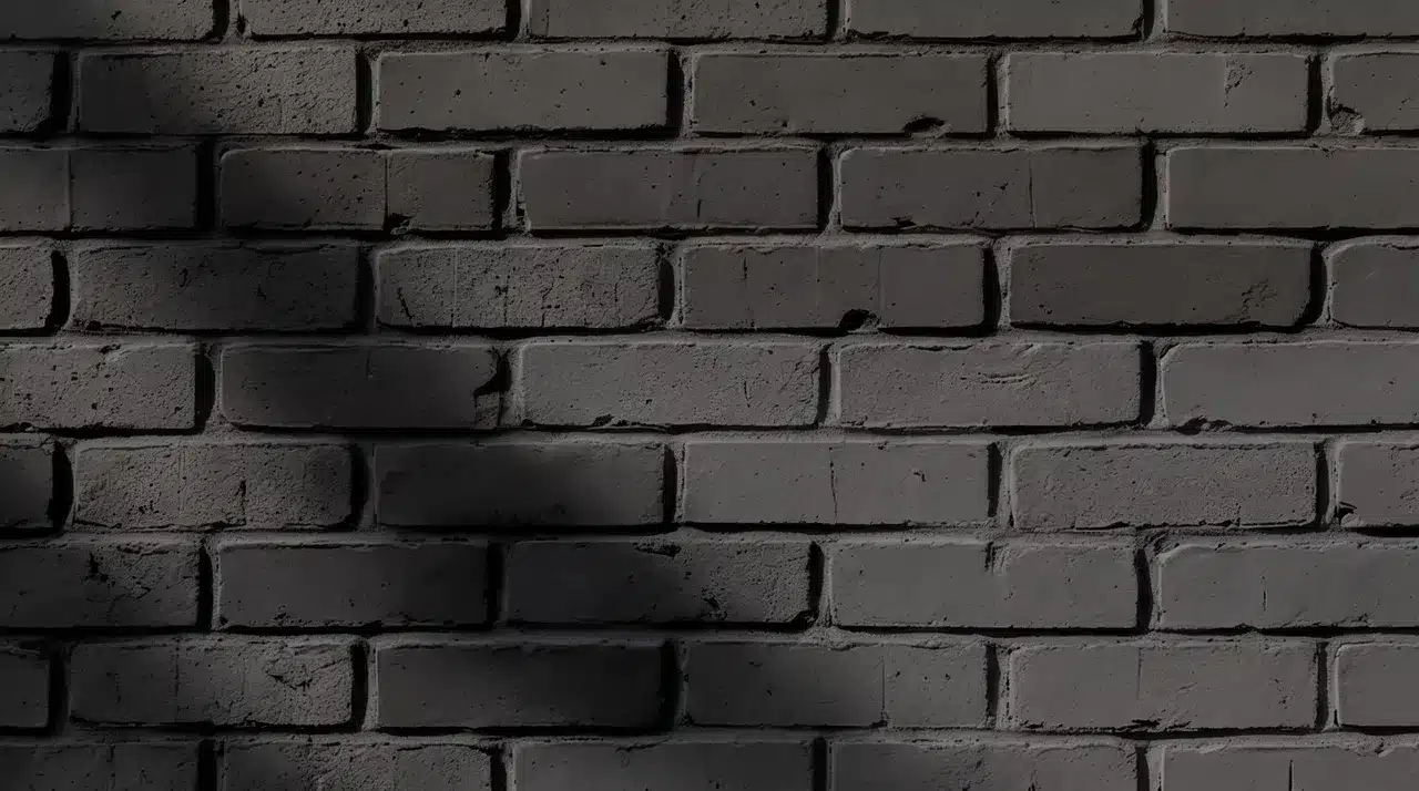 Soft black brick stain creates a deep, dramatic finish while keeping the wall&rsquo;s natural texture visible.