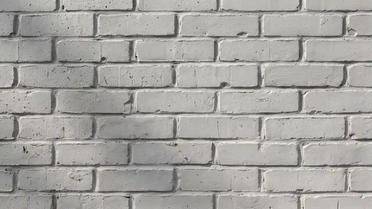 Light gray brick stain gives a textured brick wall a soft, cool-toned finish while retaining its natural details.