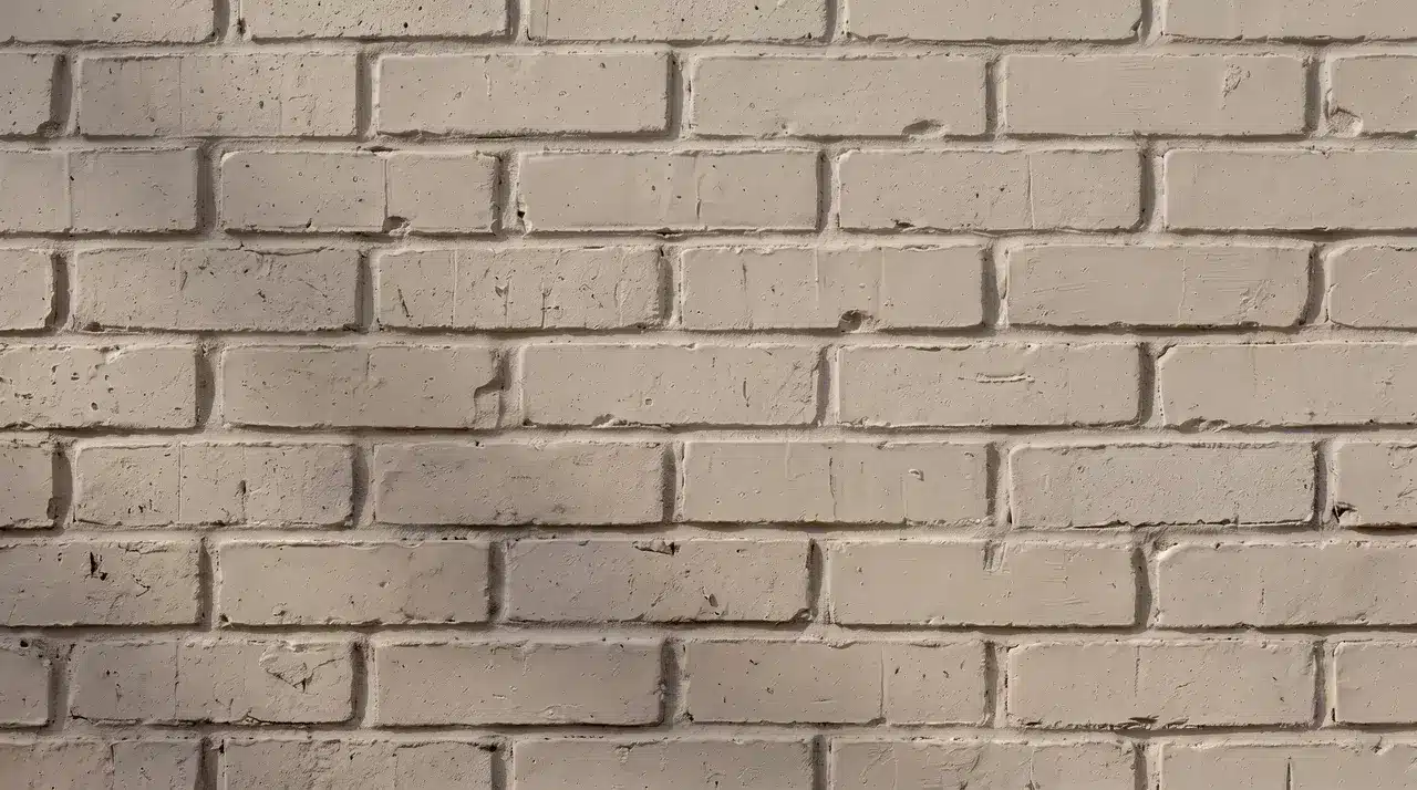 Warm gray brick stain adds a soft, earthy tone while keeping the brick wall&rsquo;s natural texture visible.