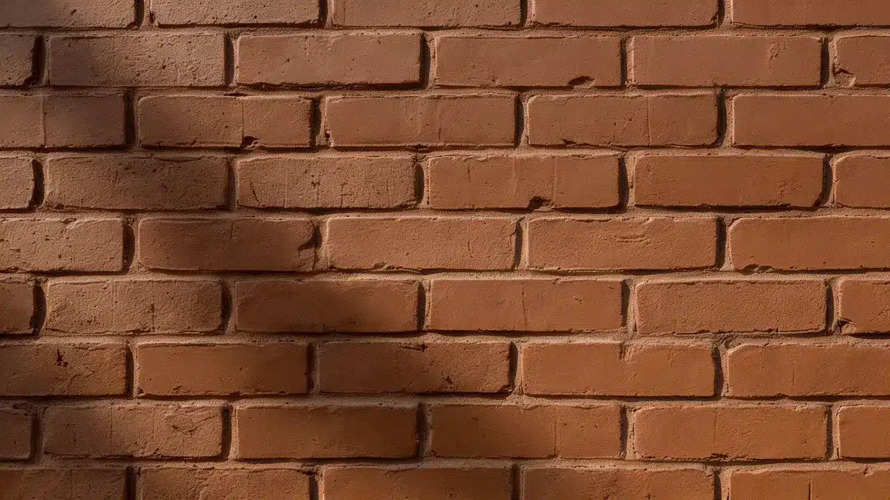 Medium brown brick stain adds a rich, earthy finish while preserving the wall&rsquo;s natural texture and imperfections.
