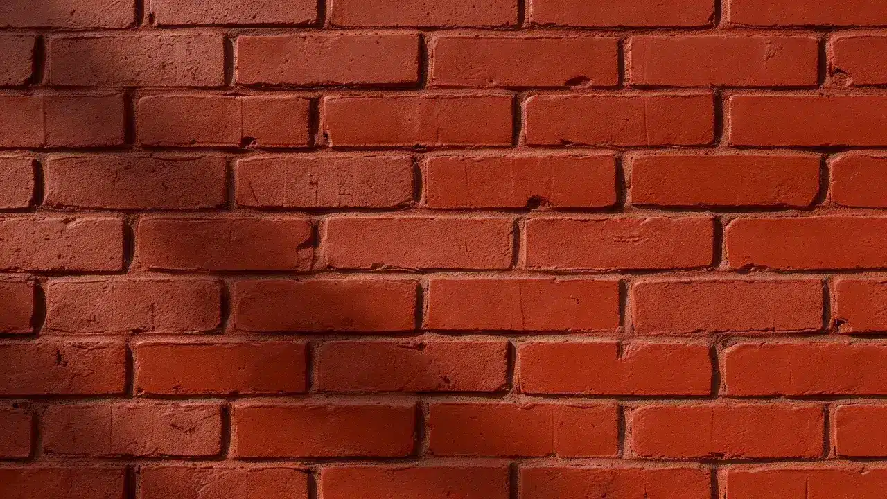 Refreshed red brick stain restores rich color while preserving the wall&rsquo;s natural texture and imperfections.