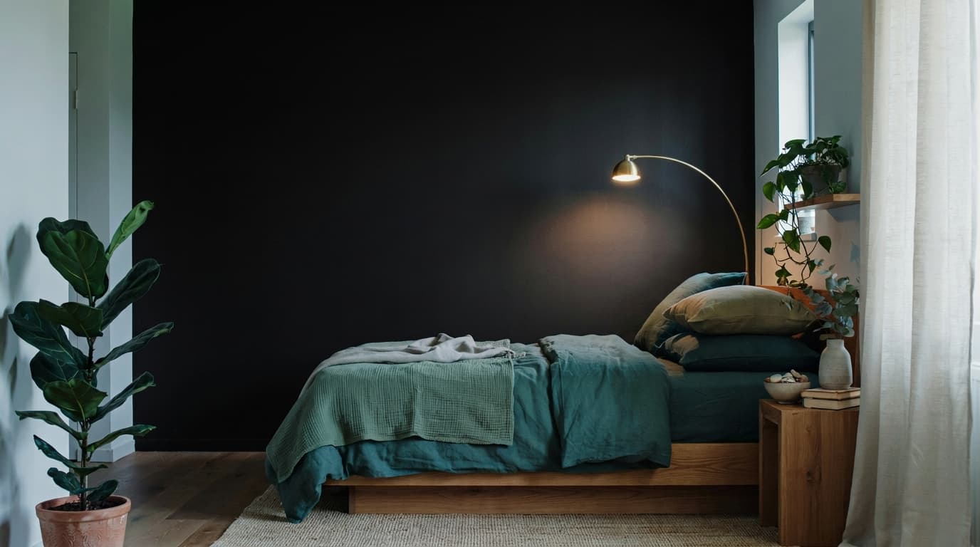 Black and green bedroom with plants and natural warm decor