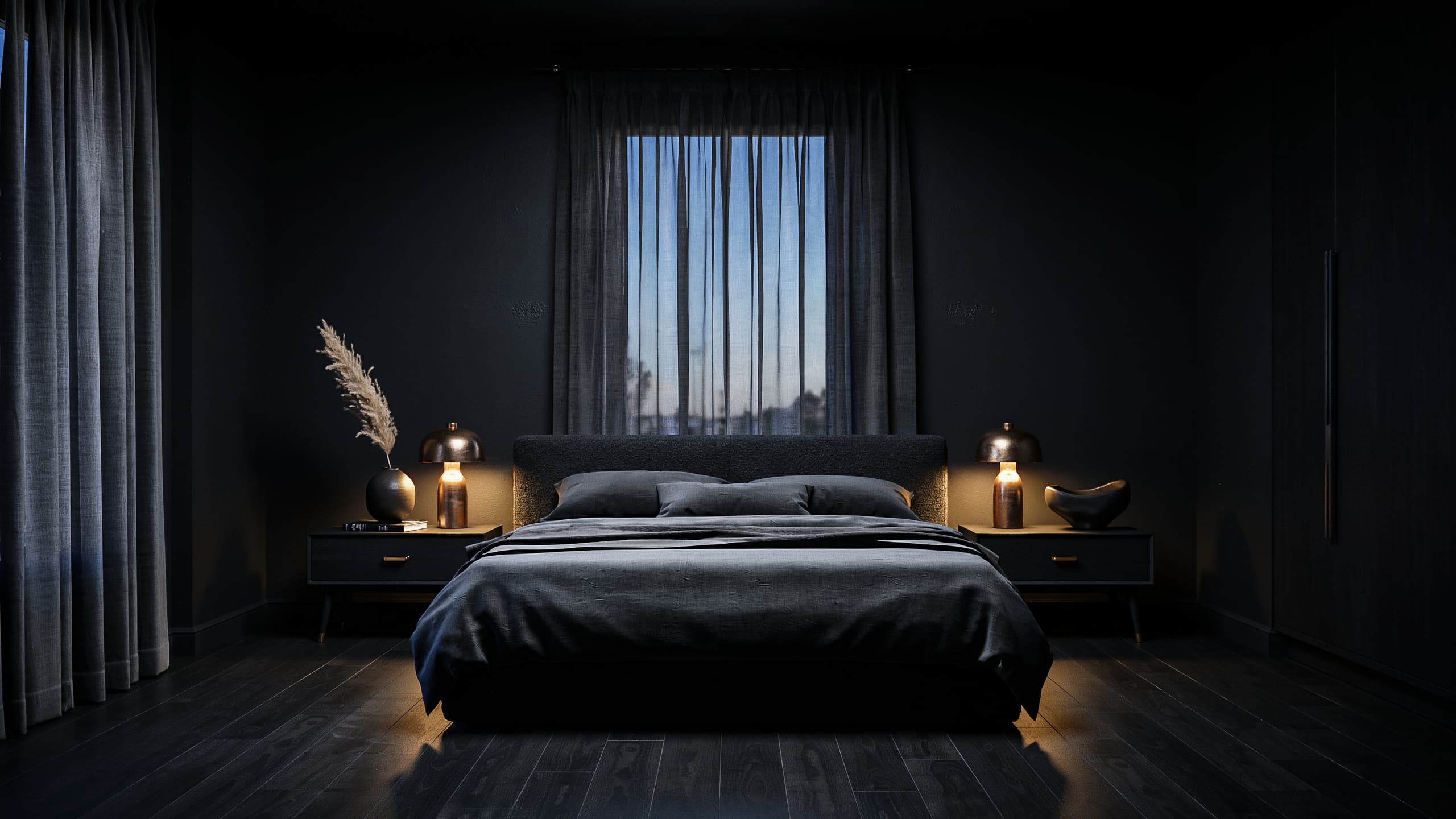 All black bedroom with matching nightstands and warm bedside lighting