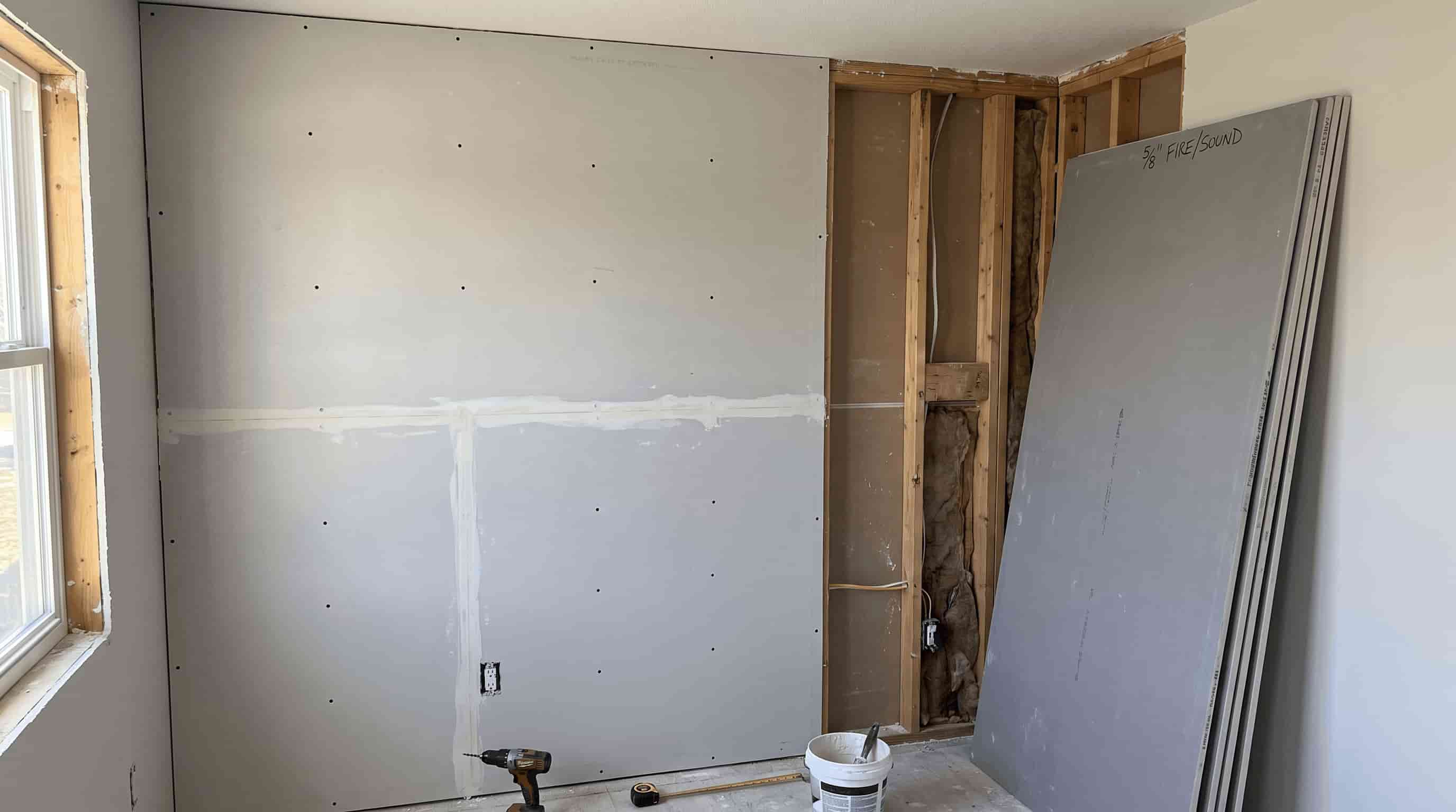 Standard ½-inch drywall installed on a residential interior wall showing thickness options and framing